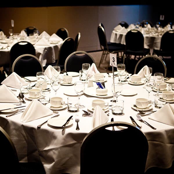 Circular tables set up for a banquet in the conference centre.